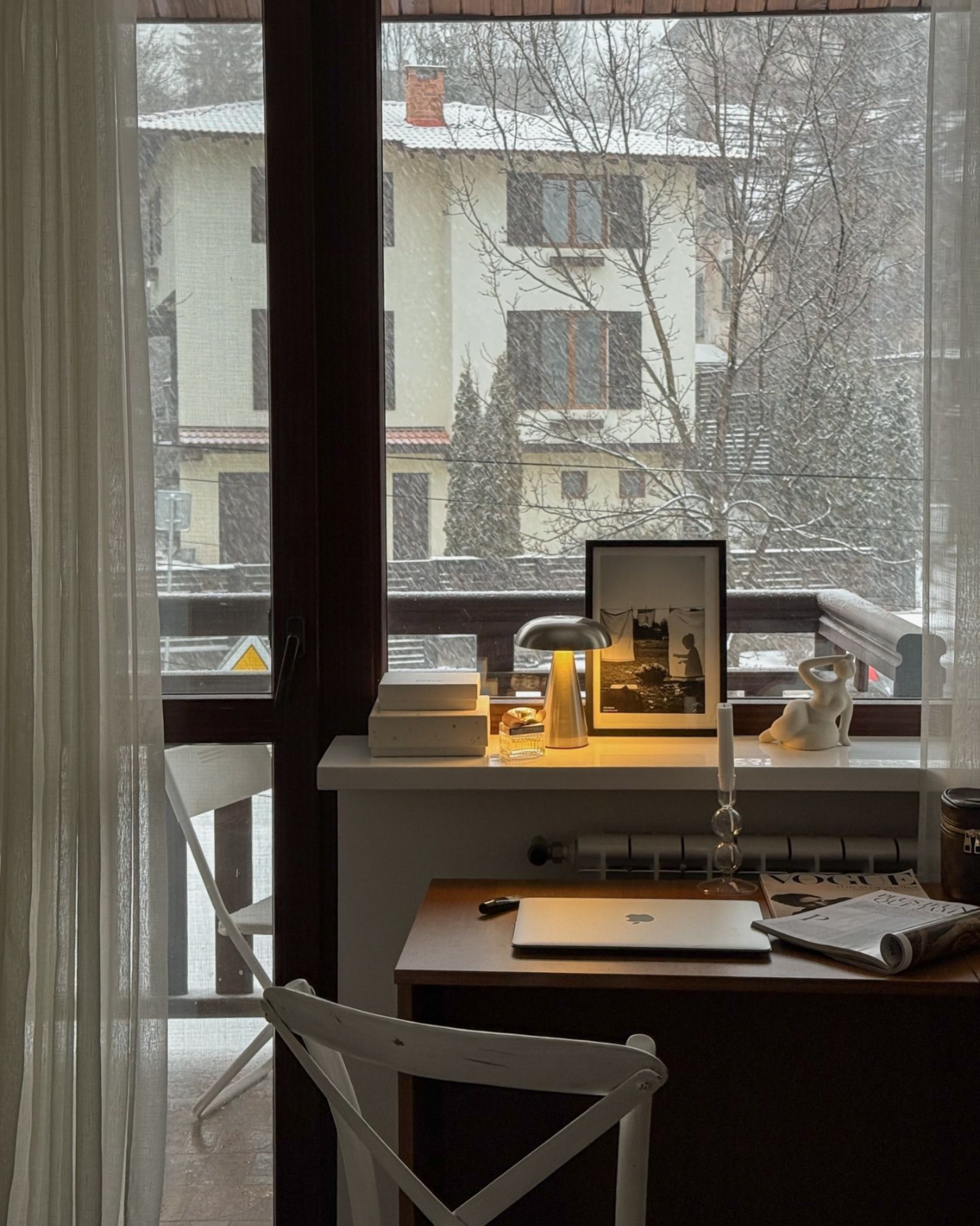 Cordless designer mushroom table lamp glowing on a white desk by a snowy window — calm minimalist home office by DecoHarmonie