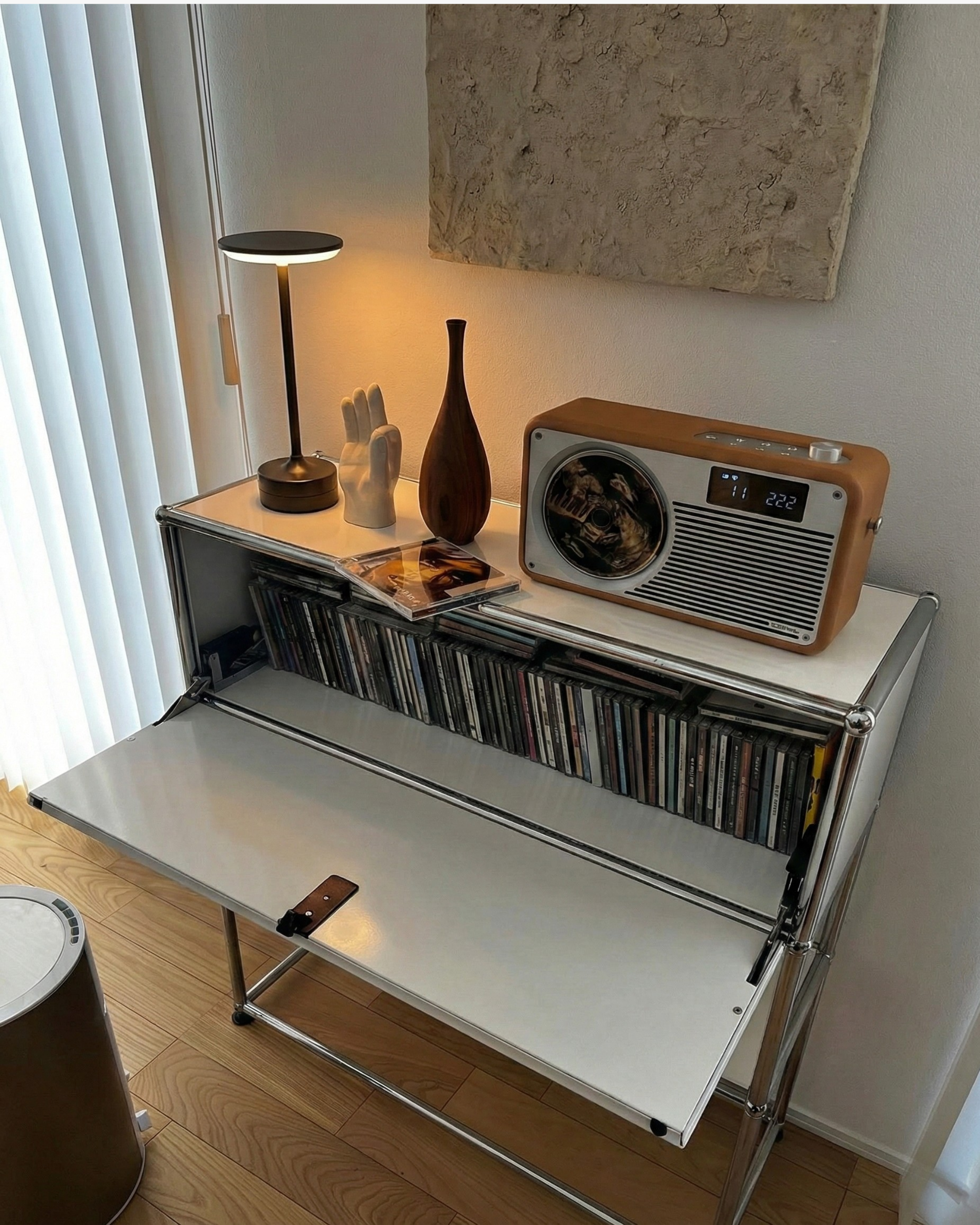 Sculptural cordless table lamp on a white modular sideboard with vintage radio — warm modernist Australian living room