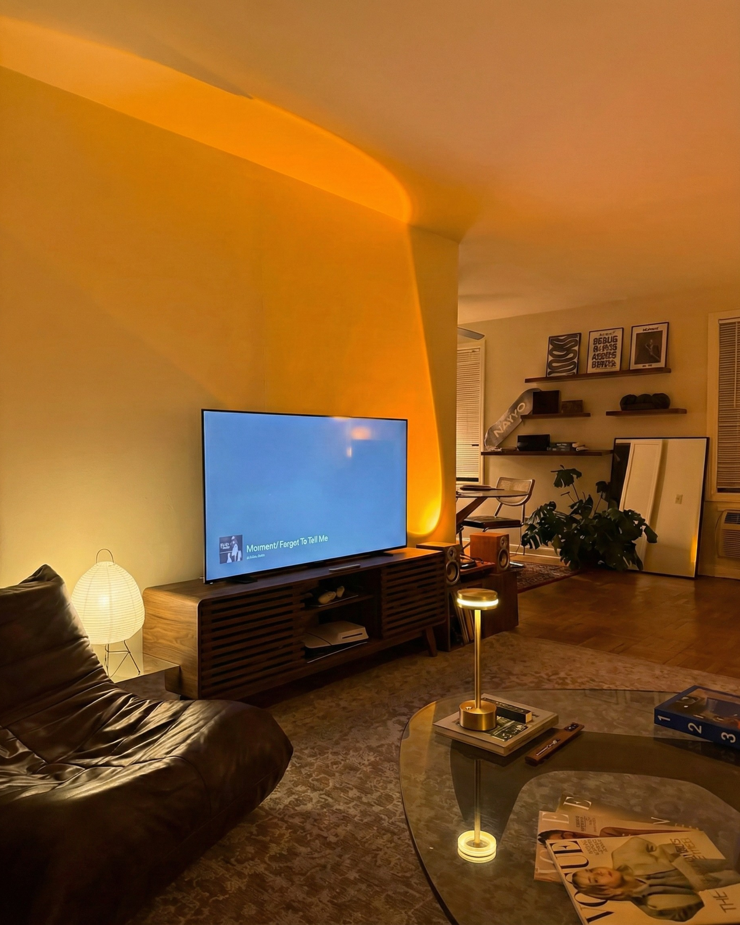 Cordless brass table lamp on a coffee table in a cosy amber-lit living room — slow evening Australian home by DecoHarmonie