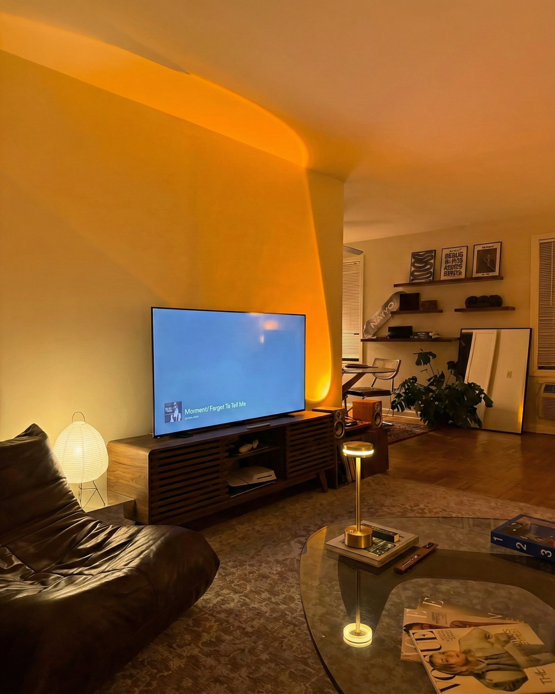 Cordless brass table lamp on a coffee table in a cosy amber-lit living room — slow evening Australian home by DecoHarmonie
