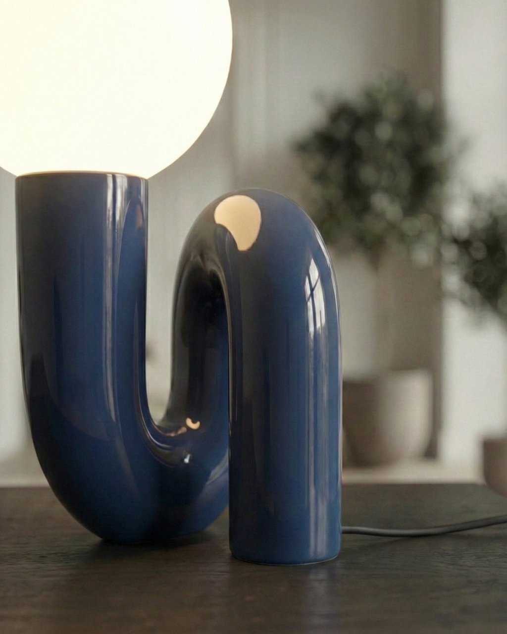 ARCA designer table lamp softening the light in a contemporary lounge — DecoHarmonie