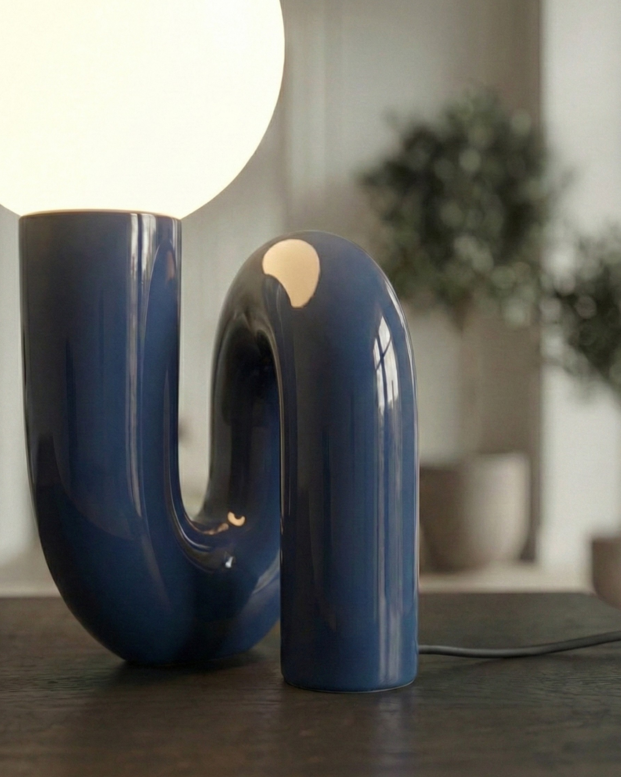 ARCA designer table lamp softening the light in a contemporary lounge — DecoHarmonie
