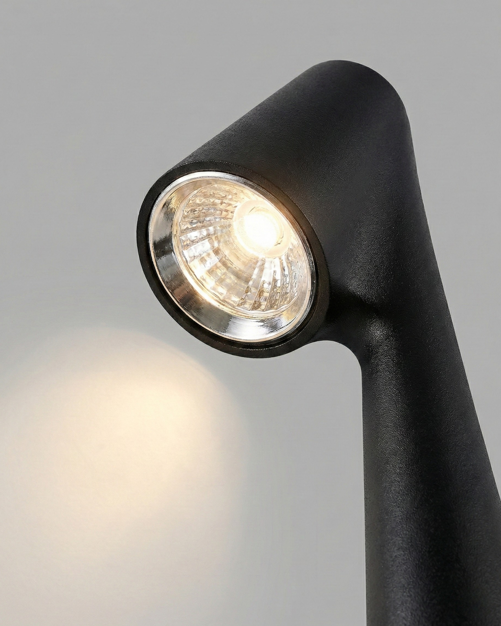 NORA cordless designer table lamp casting warm ambient light over a coffee table — DecoHarmonie