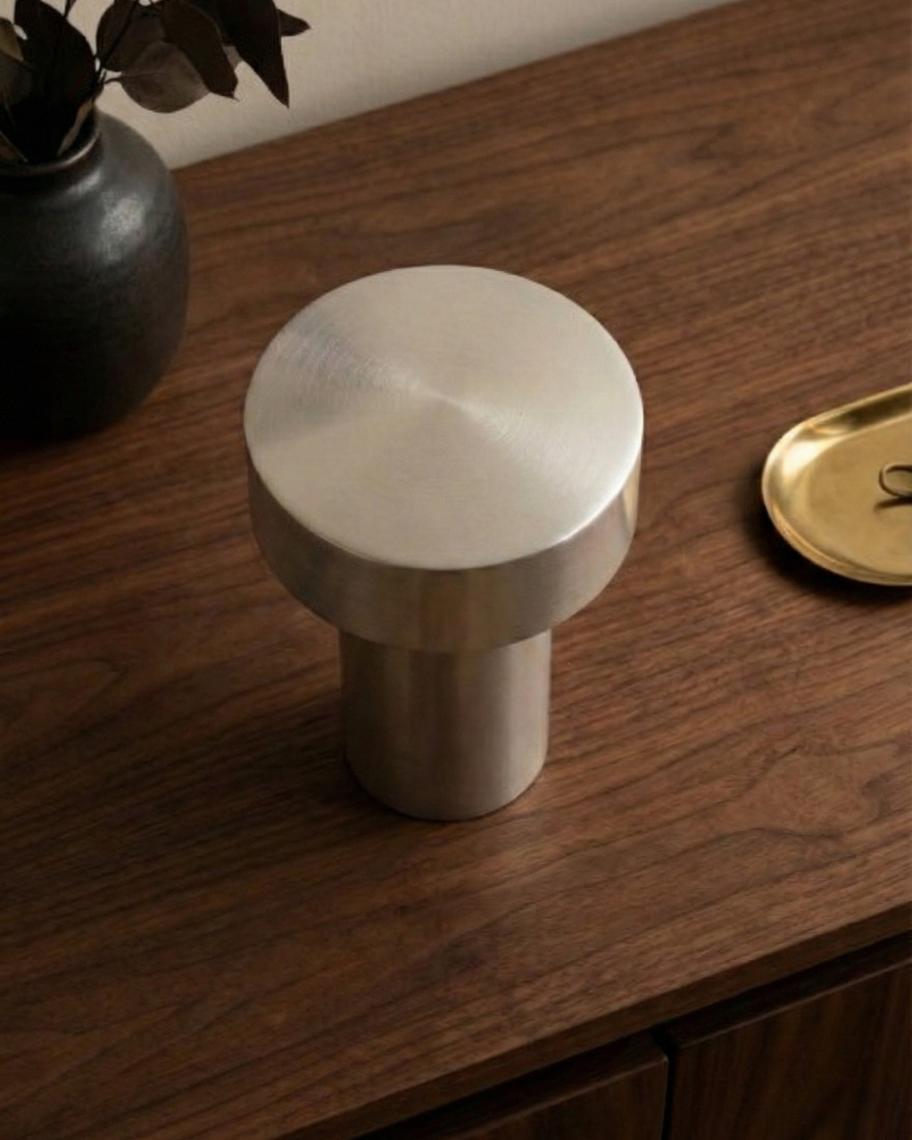 TOMI cordless designer table lamp casting warm ambient light over a coffee table — DecoHarmonie