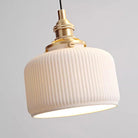 Modern ceramic pendant light with ribbed shade and brass details