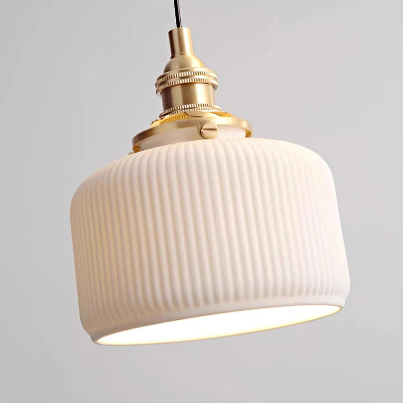 Modern ceramic pendant light with ribbed shade and brass details
