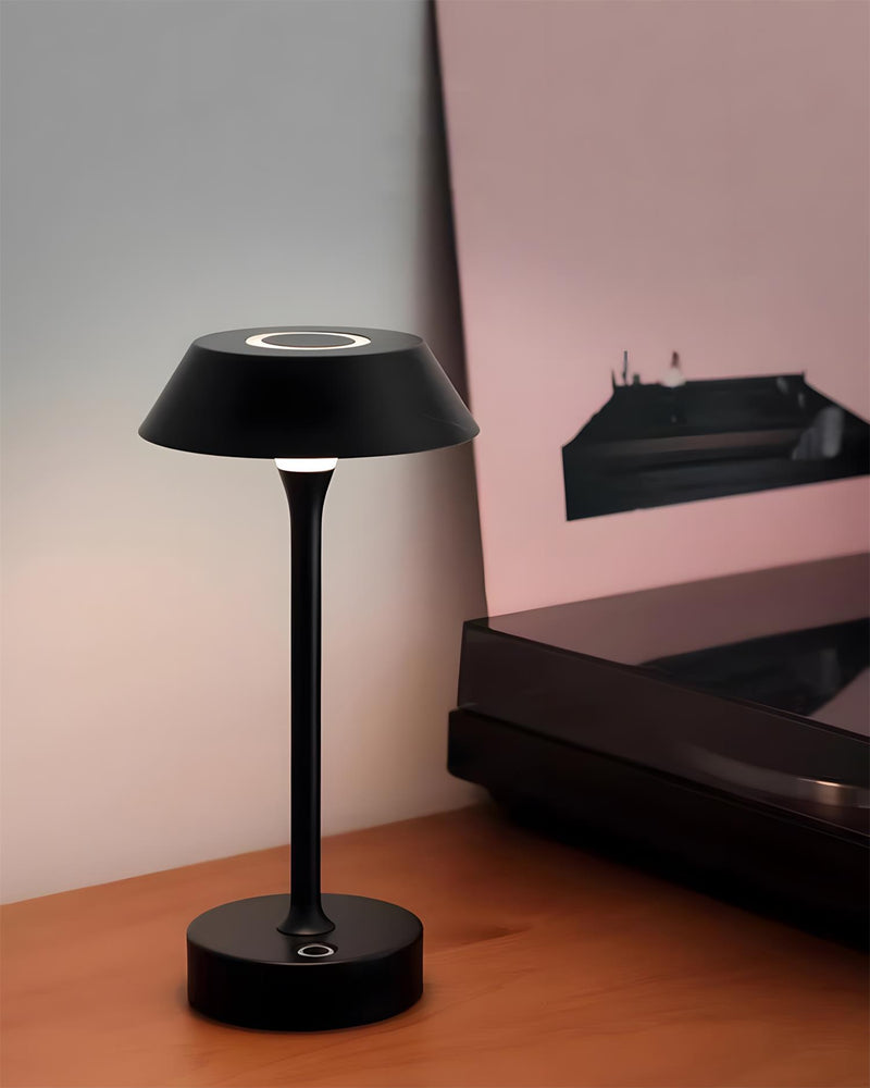 RUVA designer table lamp casting warm ambient light over a coffee table — DecoHarmonie