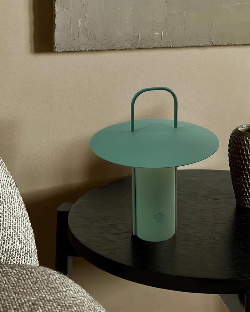 ORKA designer table lamp casting warm ambient light over a coffee table — DecoHarmonie