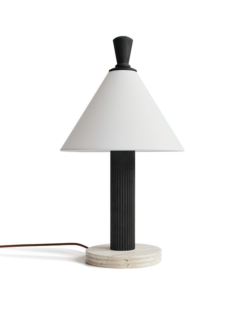 TÉA designer table lamp shown on a bedside table in a modern bedroom — DecoHarmonie