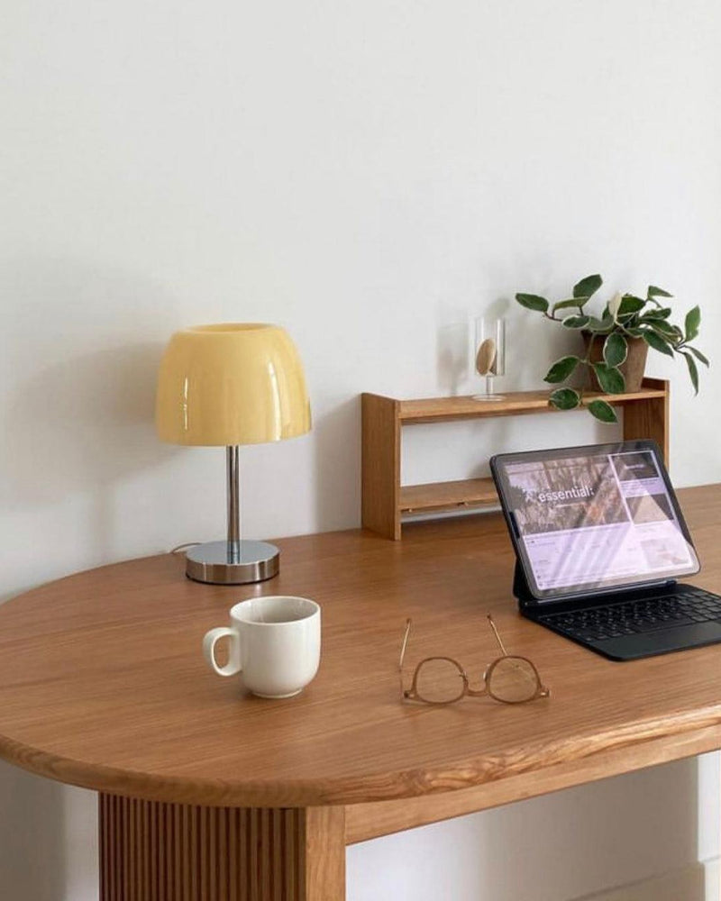 RANGU designer table lamp casting warm ambient light over a coffee table — DecoHarmonie