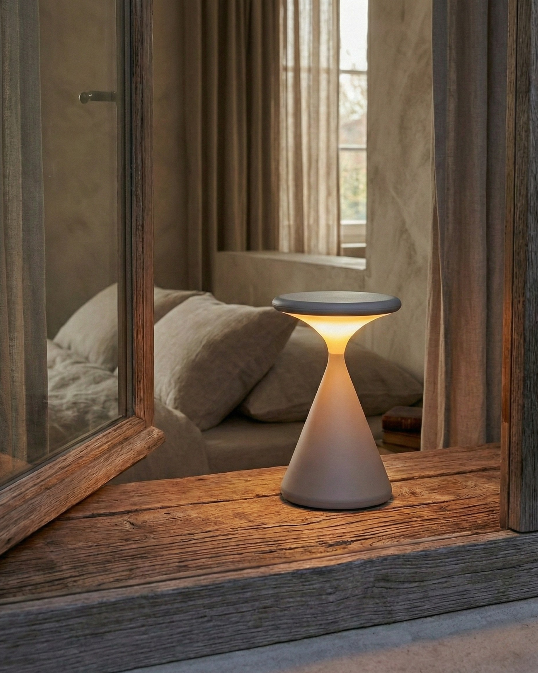 KONI cordless designer table lamp shown on a bedside table in a modern bedroom — DecoHarmonie