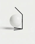 ENNA designer table lamp with white opal glass sphere globe on angled matte black metal frame | DecoHarmonie