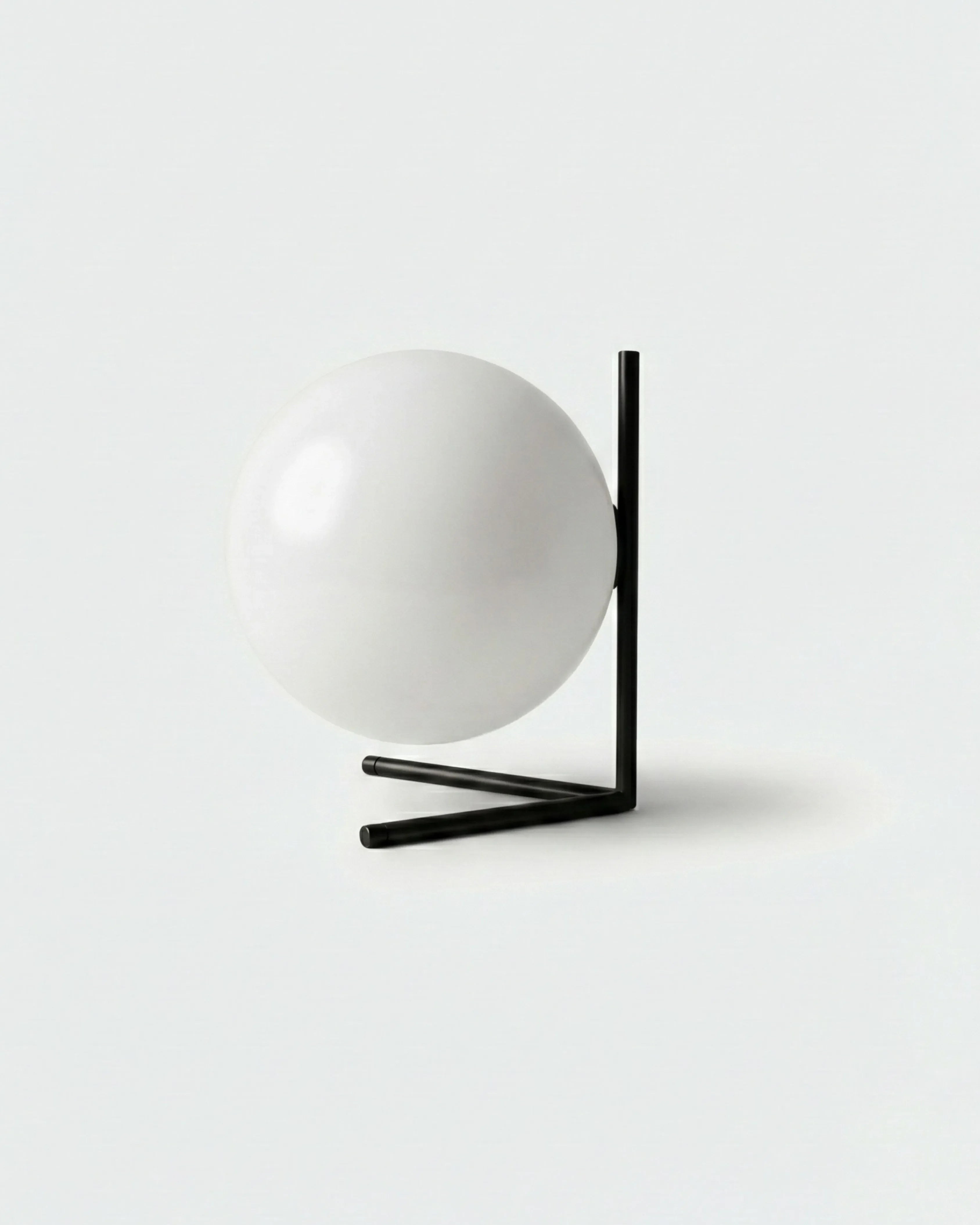 KAEN designer table lamp with white glass sphere cradled in angular black metal frame | DecoHarmonie