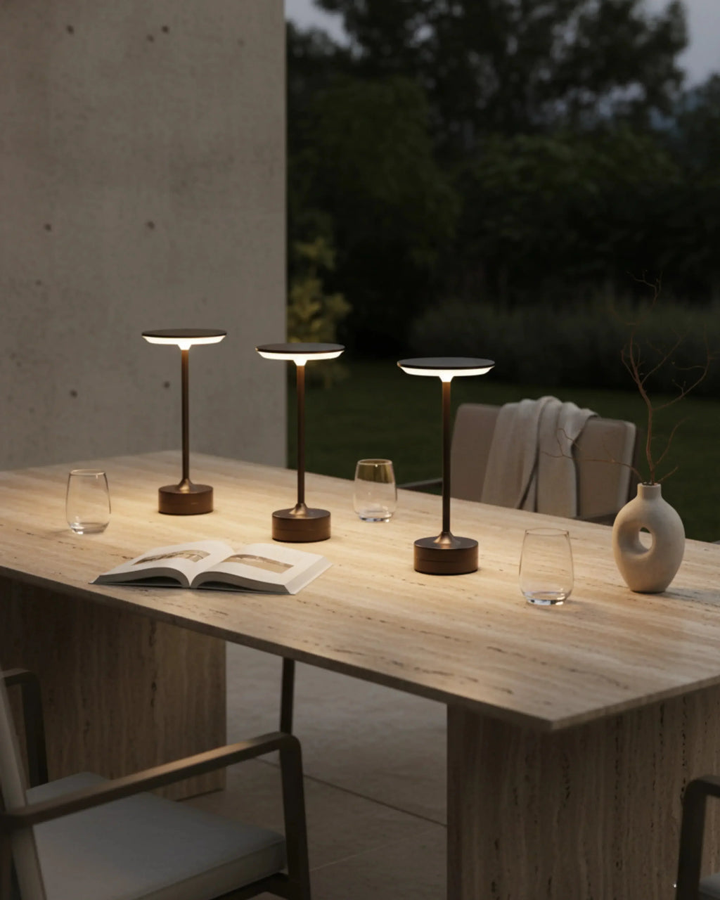 LORA cordless designer table lamp casting warm ambient light over a coffee table — DecoHarmonie