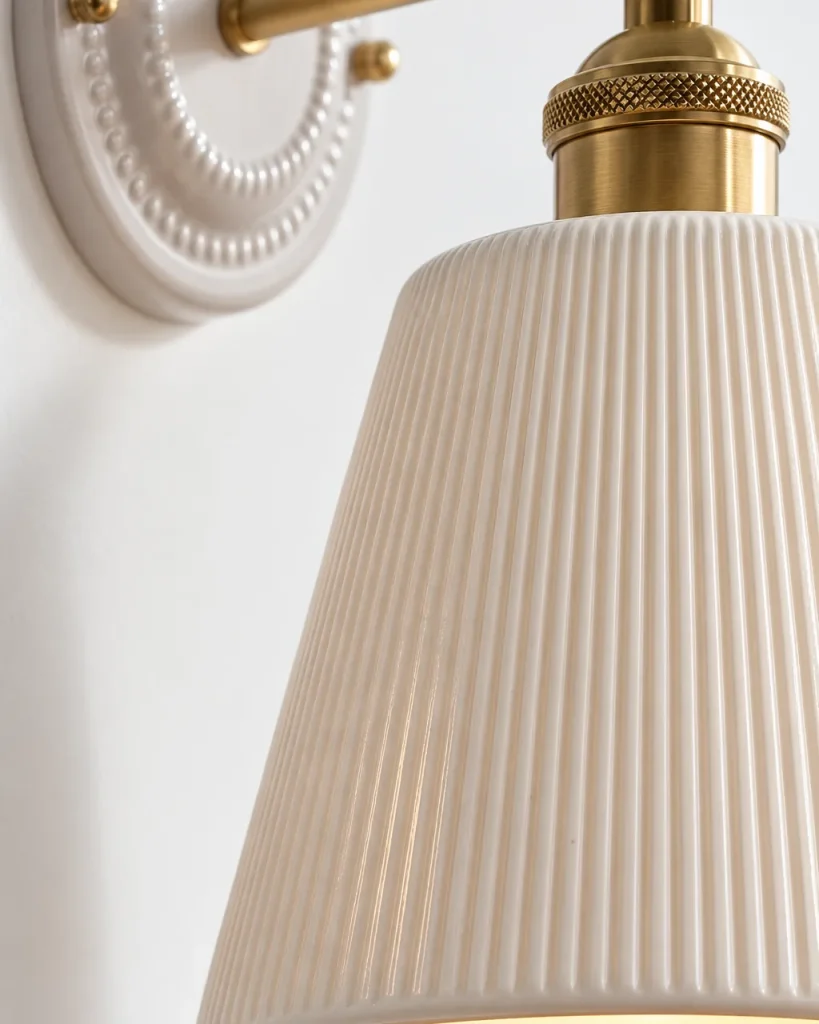 Applique PLOSIO, paralume in ceramica rigata su braccio in ottone – dettaglio delle righe e del portalampada in ottone